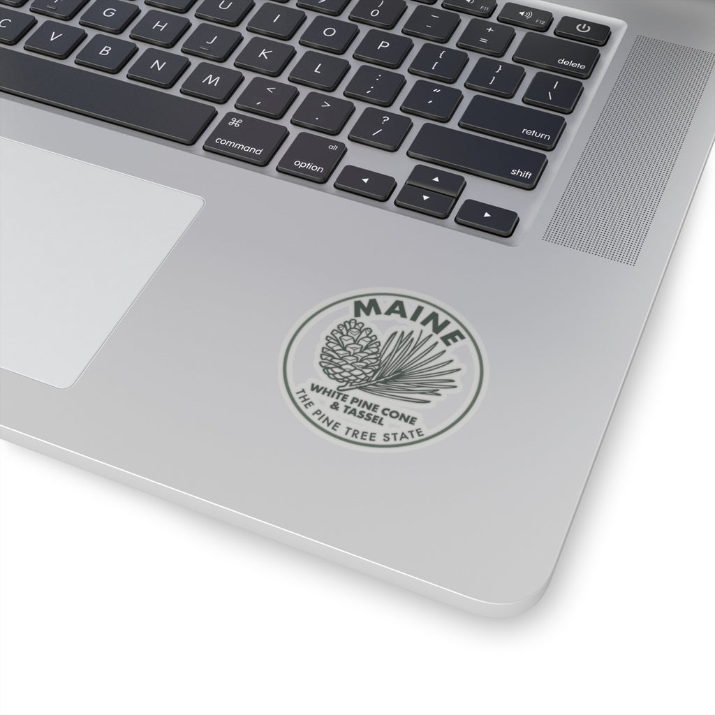 Maine white pine cone and tassel sticker on laptop lid, circular transparent vinyl decal
