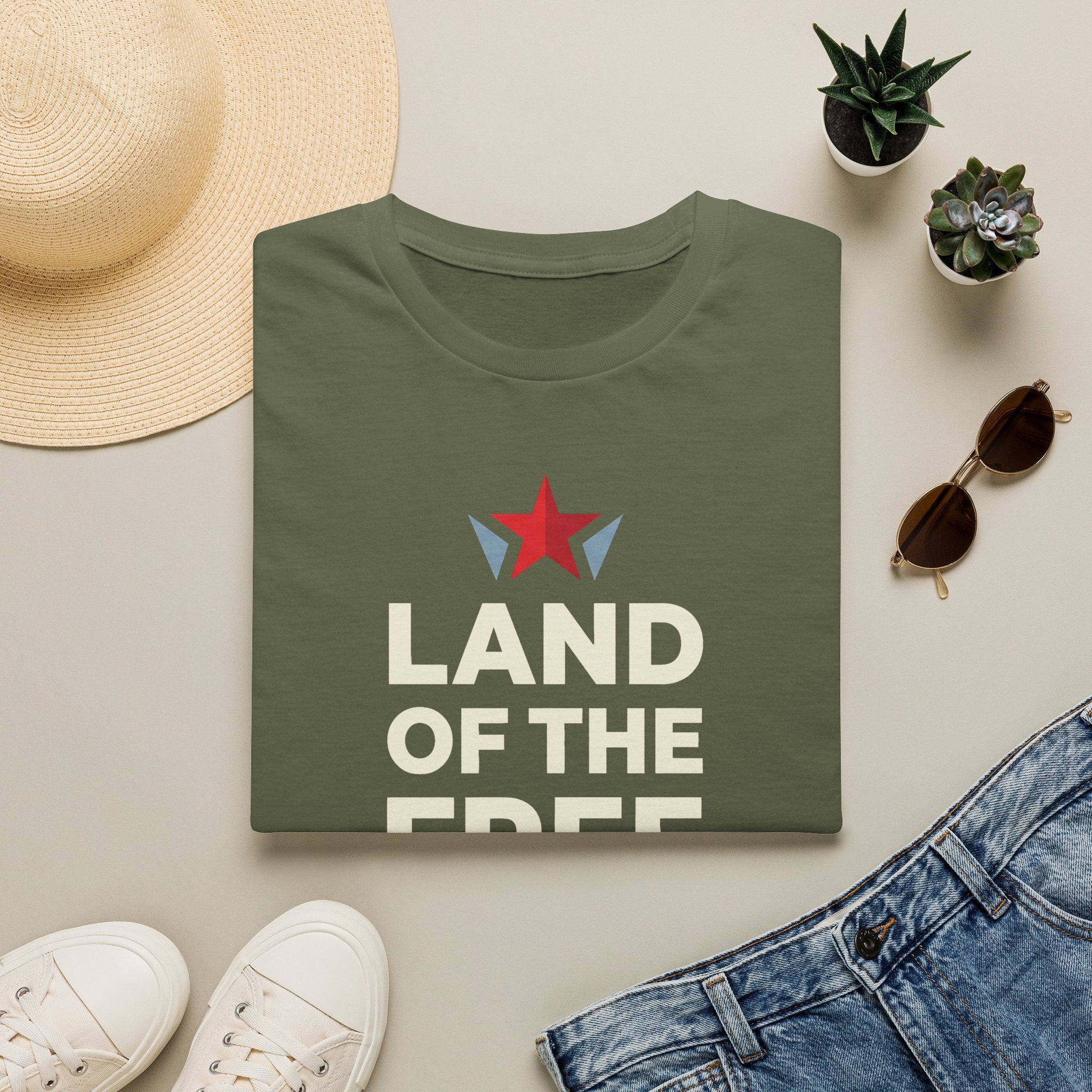 Olive green T-shirt with red star graphic and bold white patriotic text, crew neck