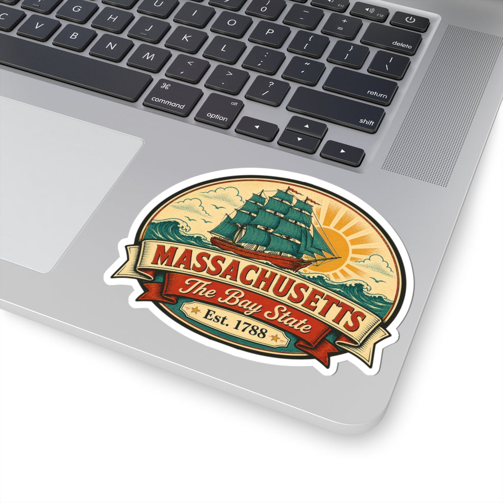 Vinyl sticker on laptop keyboard showing Massachusetts Bay State tall ship emblem