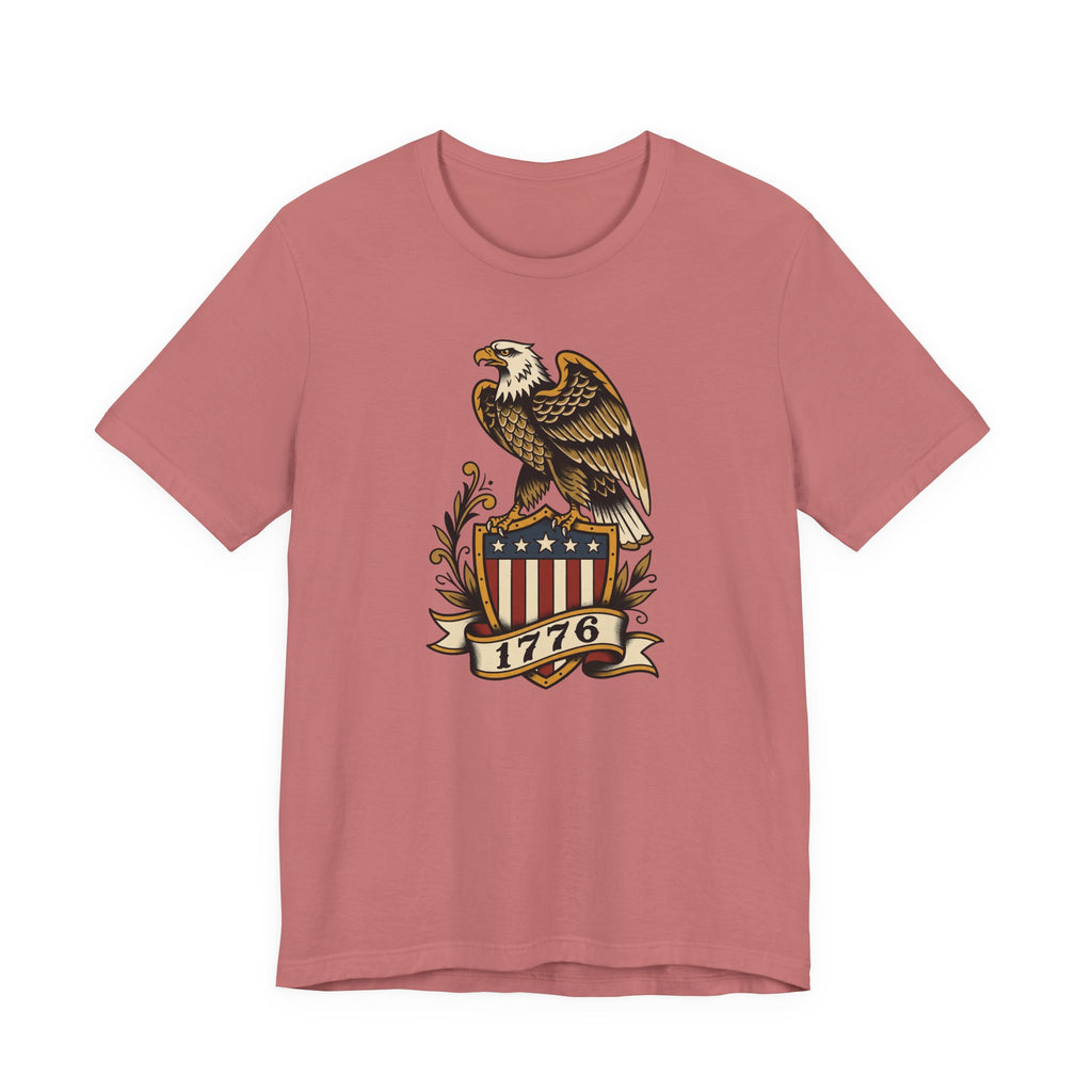 Dusty rose t-shirt with eagle shield graphic and banner reading 1776