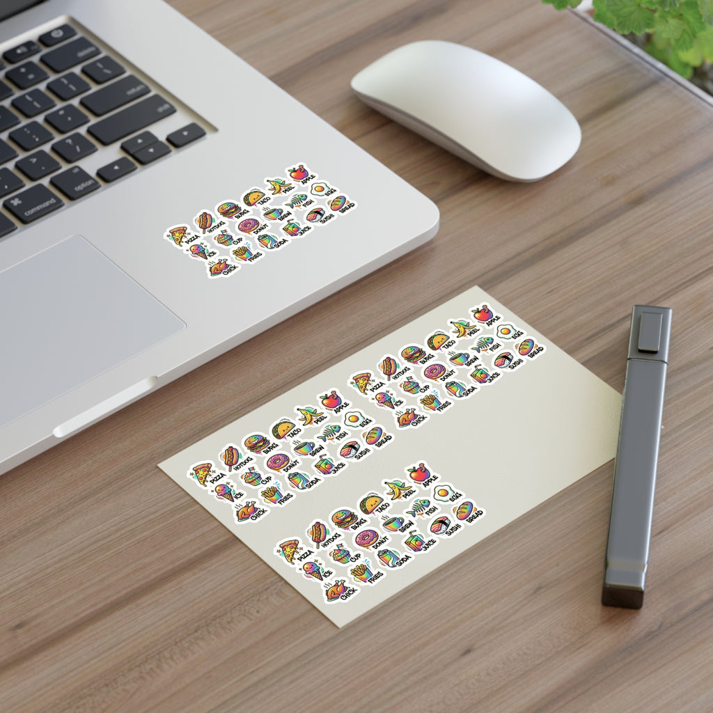 Food icon stickers arranged on a planner sheet on a desk near a laptop