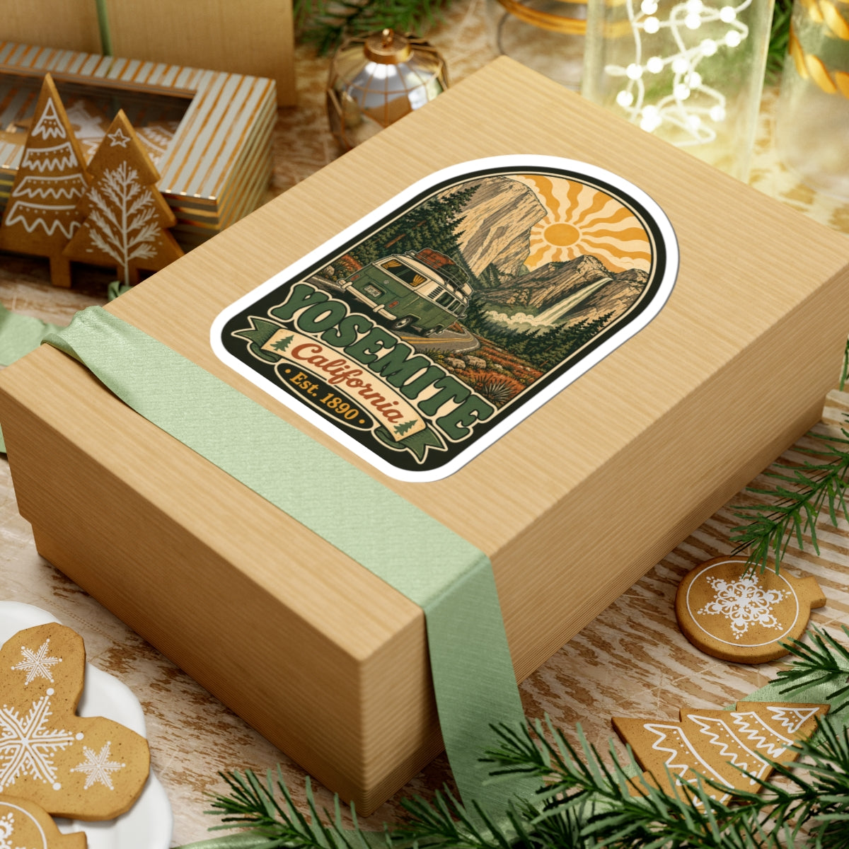 Arched vintage park sticker on a wrapped gift box, showing camper van and “Est. 1890”