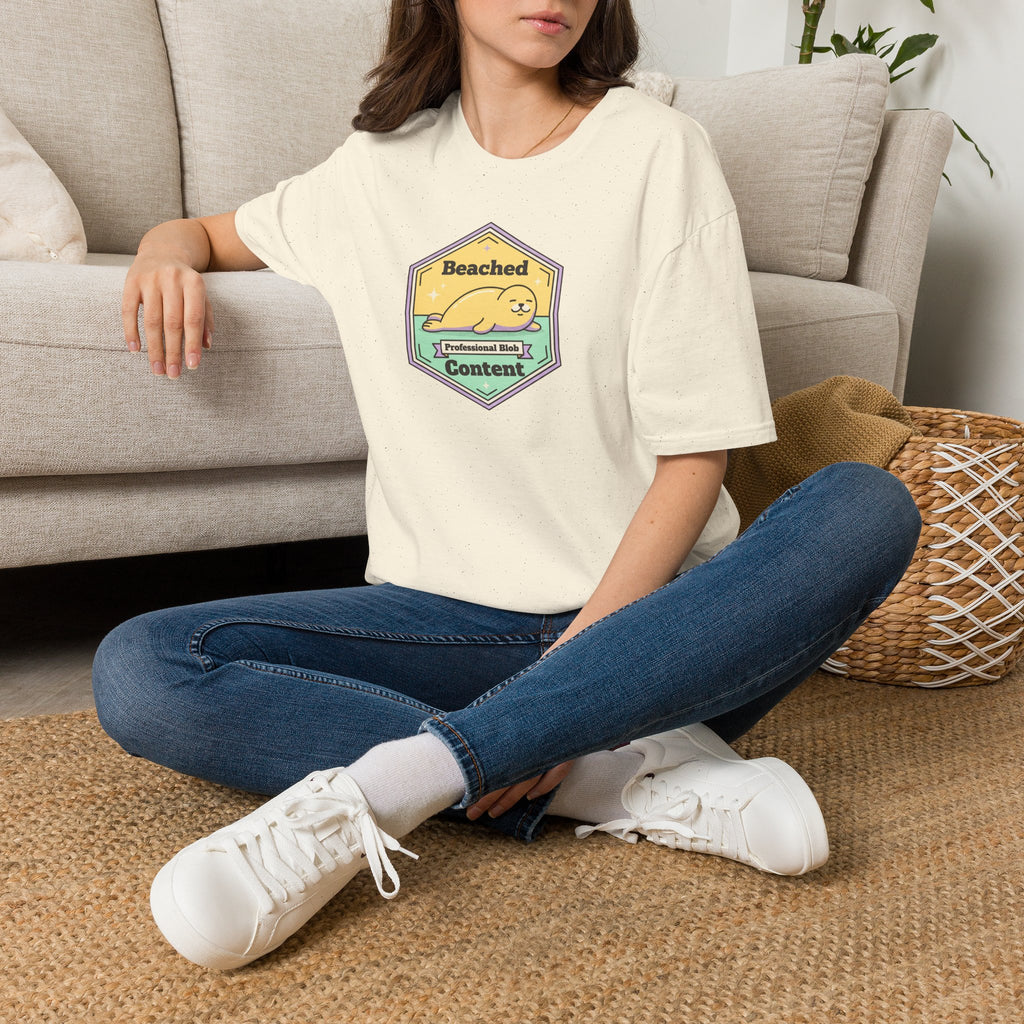 Natural/off-white T-shirt with seal badge graphic on chest, crew neck, short sleeves
