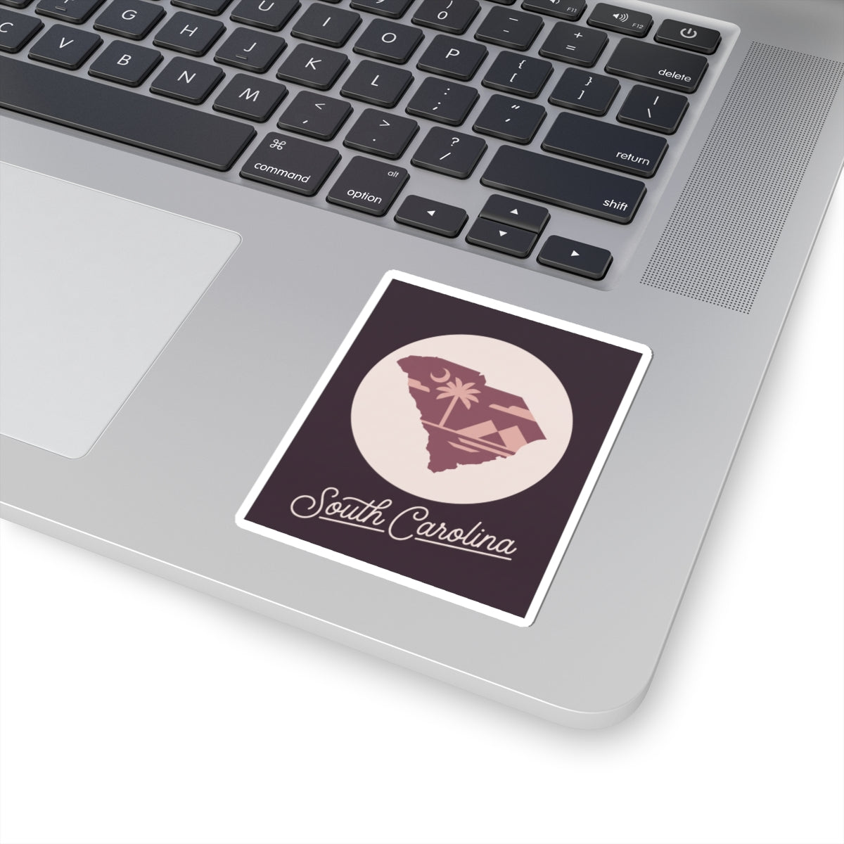 South Carolina sticker placed on a laptop lid with palm tree circular emblem