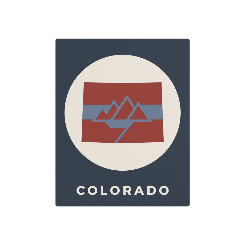 Colorado metal art sign, dark blue panel with mountain flag graphic inside cream circle