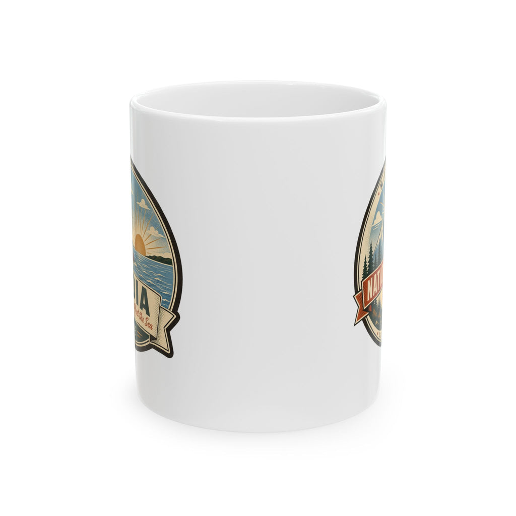 White ceramic coffee mug with side travel badge graphic, no handle visible.