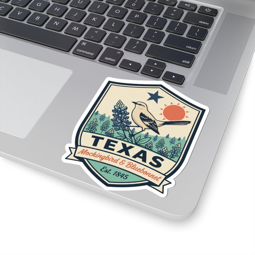 Texas travel badge decal on laptop screen, mockingbird with bluebonnets, TEXAS, Est. 1845