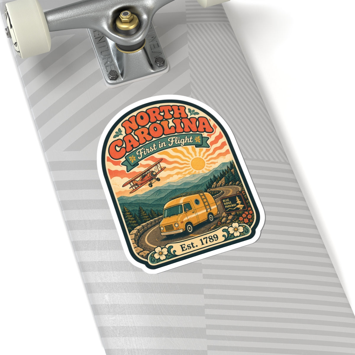 North Carolina die-cut sticker on a luggage tag, with orange van, airplane, and Est. 1789.