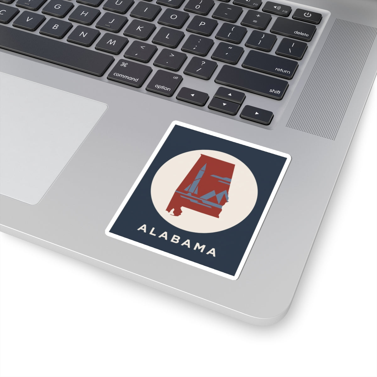Square sticker with ALABAMA text, red state landmark in white circle on navy