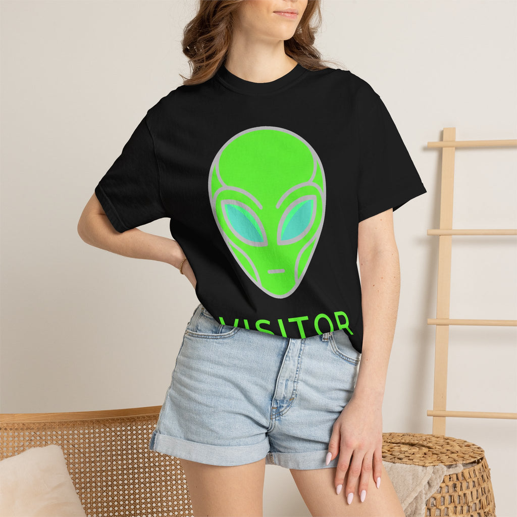 Alien visitor T-shirt worn in black with neon green alien face and partial “VISITOR” text