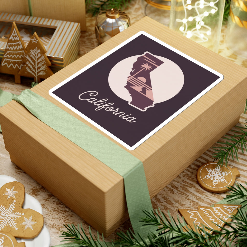 California state silhouette sticker on a wrapped package, mauve “California” script