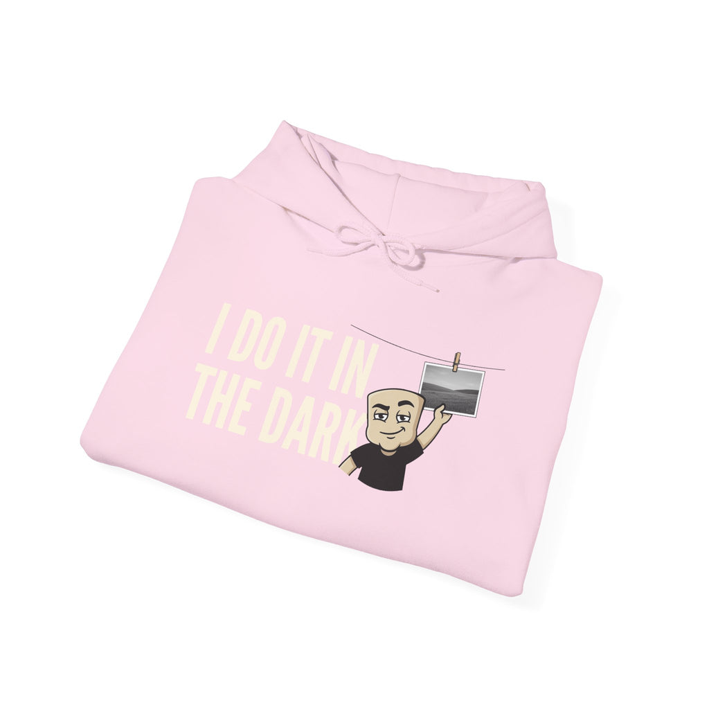 Light pink pullover hoodie with drawstring hood and 'I do it in the dark' graphic