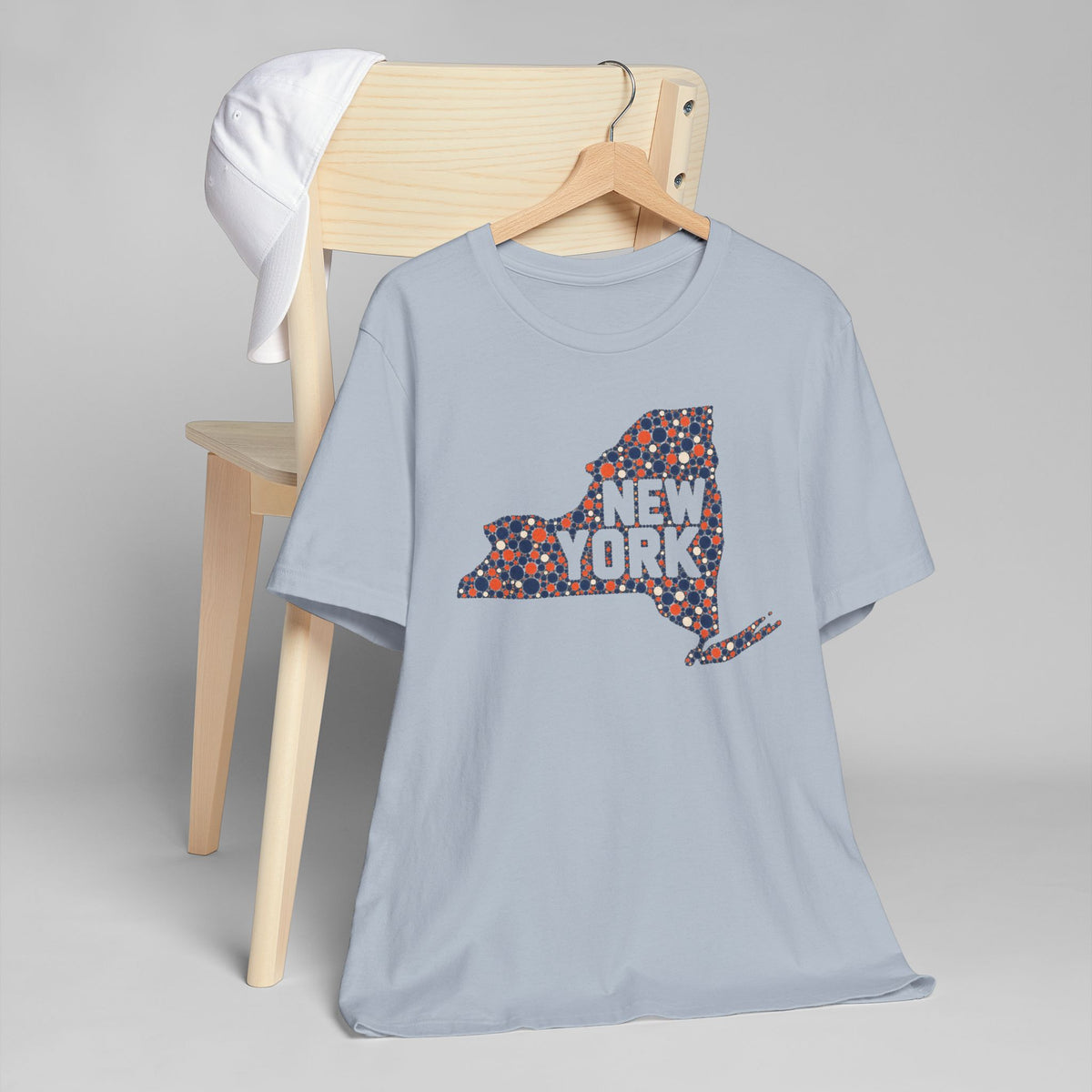 Light blue T-shirt with colorful dotted New York state graphic across chest