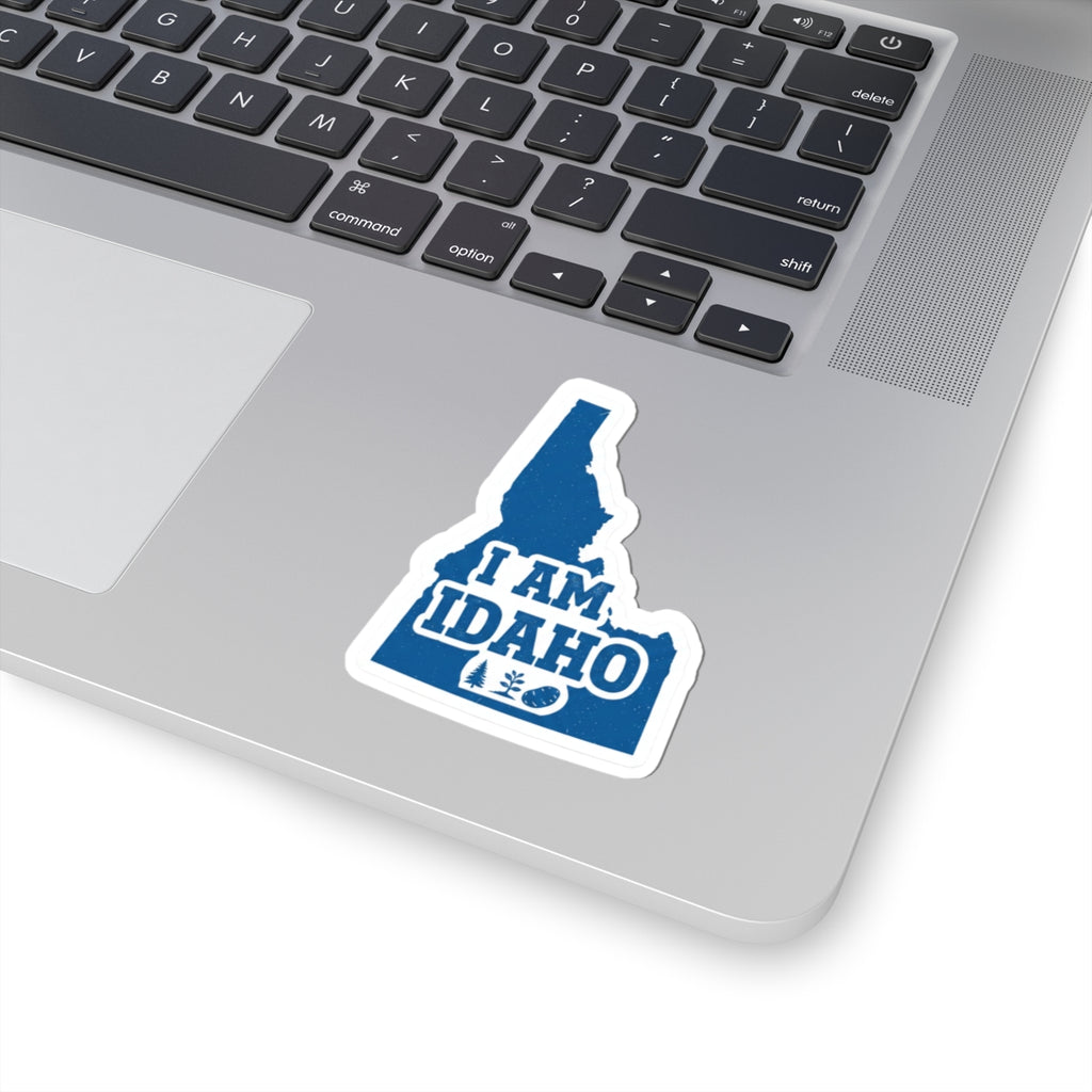 Kiss-cut decal on laptop: blue Idaho silhouette with “I AM IDAHO” lettering