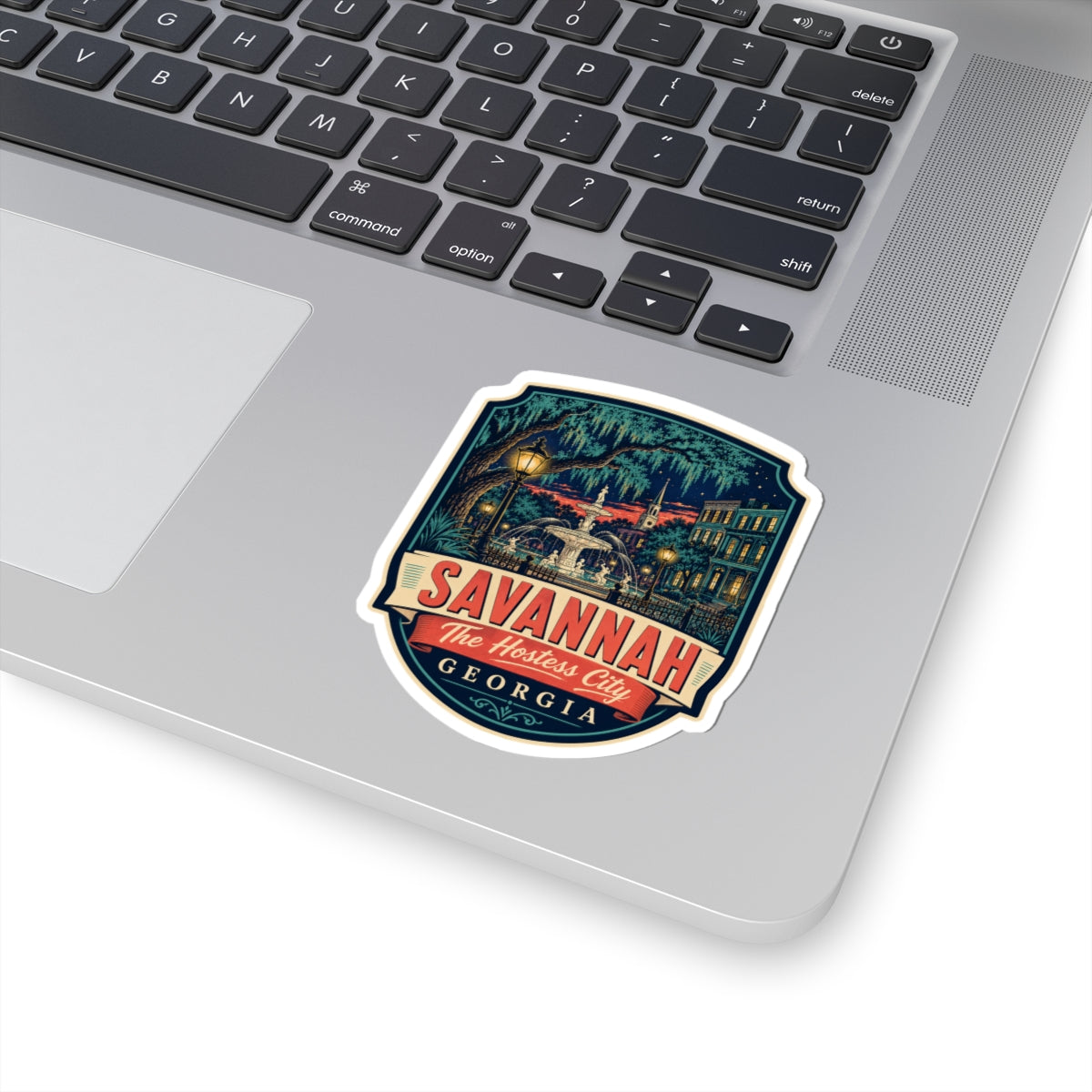 Savannah luggage tag sticker on laptop keyboard, red SAVANNAH and GEORGIA label