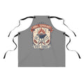 Gray BBQ apron with black neck ties and retro badge graphic
