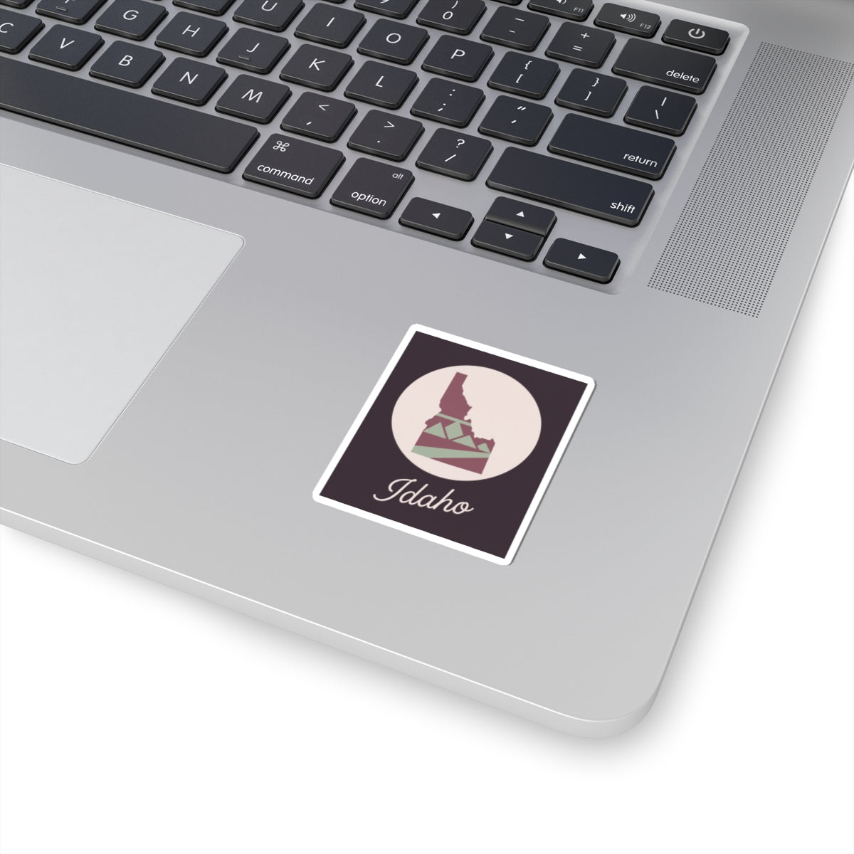 Square mauve Idaho state silhouette sticker with circular emblem and 'Idaho' script