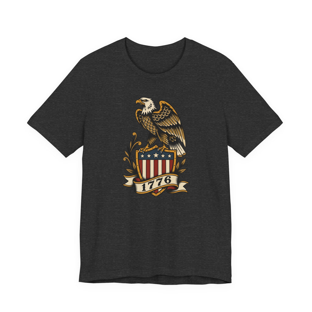 Graphic T-shirt, dark heather grey/black, front features gold eagle and 1776 shield logo.