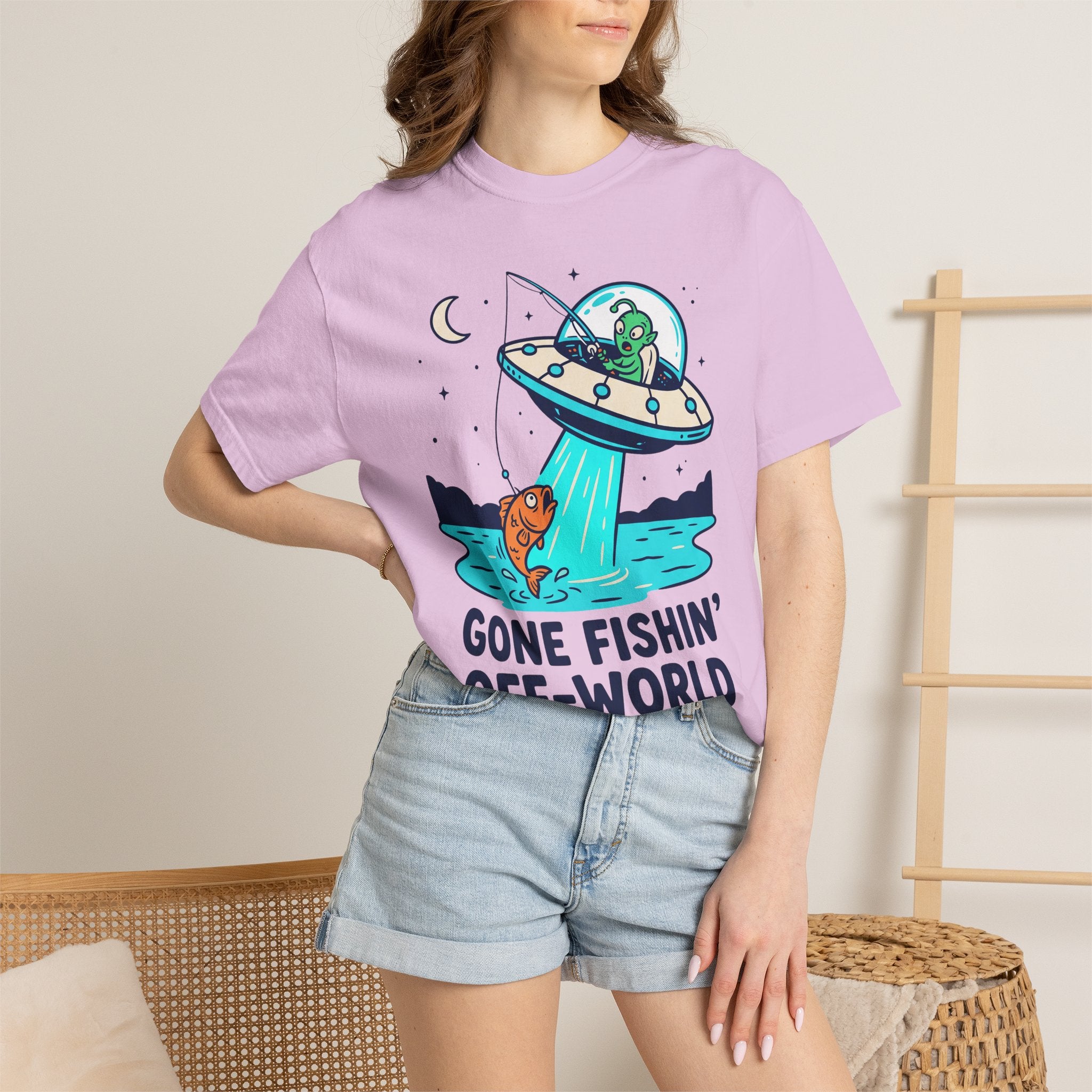 Purple graphic alien fishing t-shirt with UFO and fish illustration