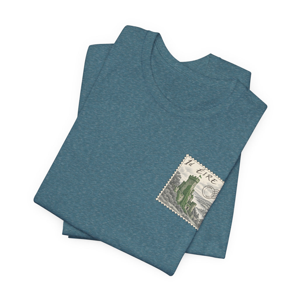 Teal heather T-shirt, folded view with small vintage postage stamp graphic on chest.