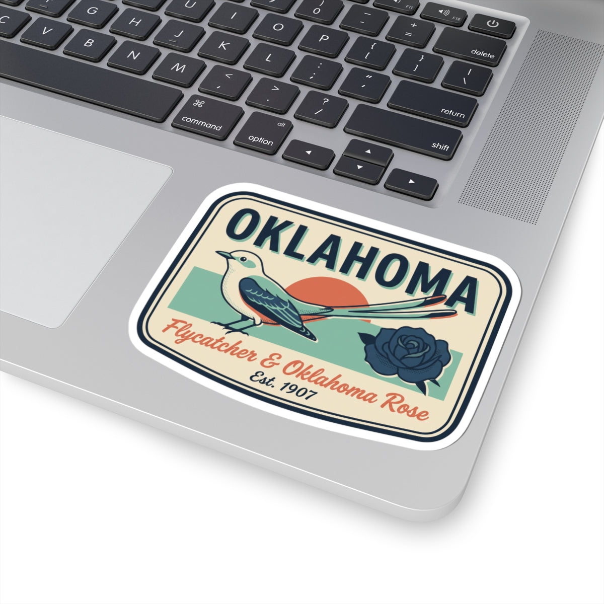 Oklahoma sticker on laptop lid, vintage badge with flycatcher and rose