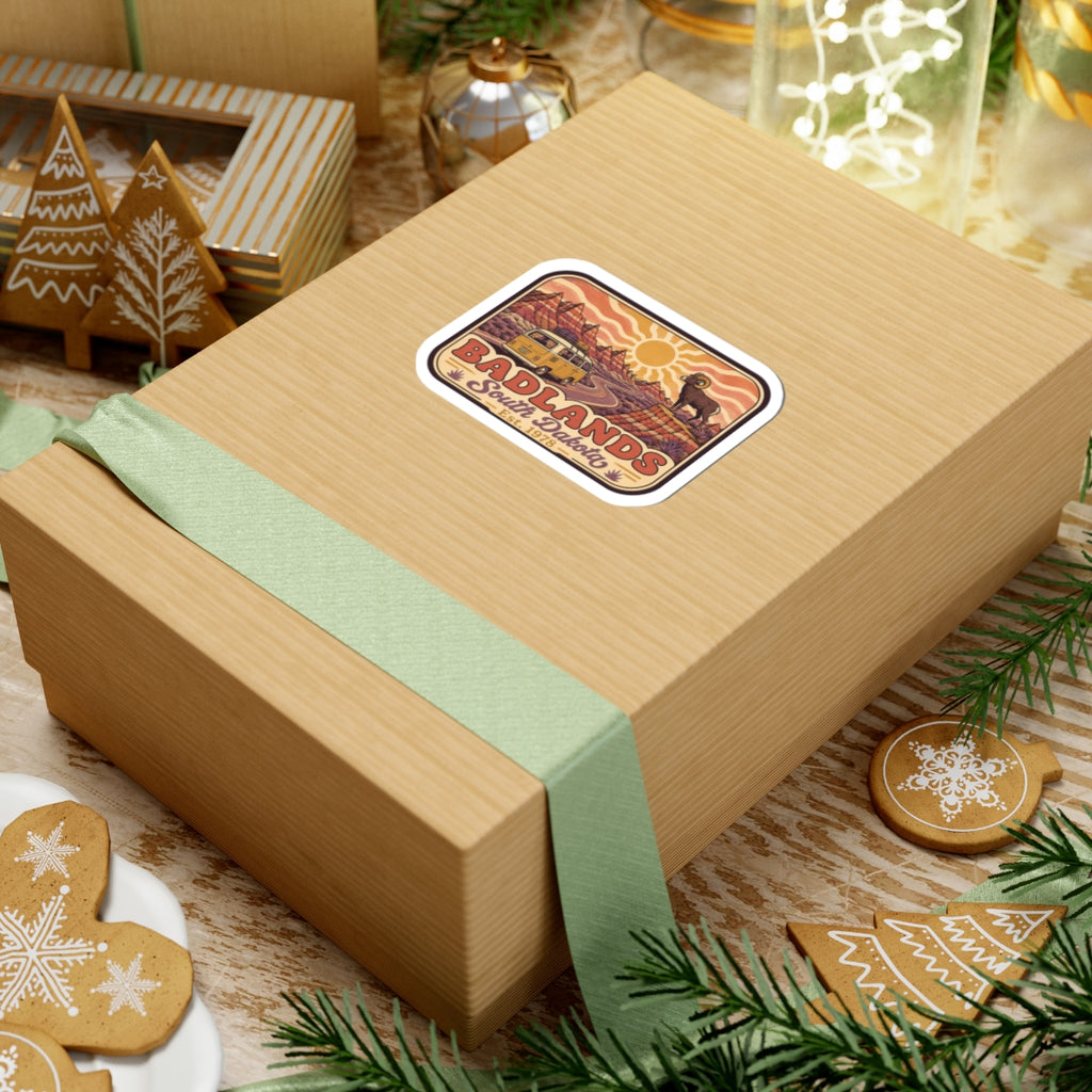 Kiss-cut sticker on a gift box: desert landscape camper van, bighorn sheep, Badlands graphic