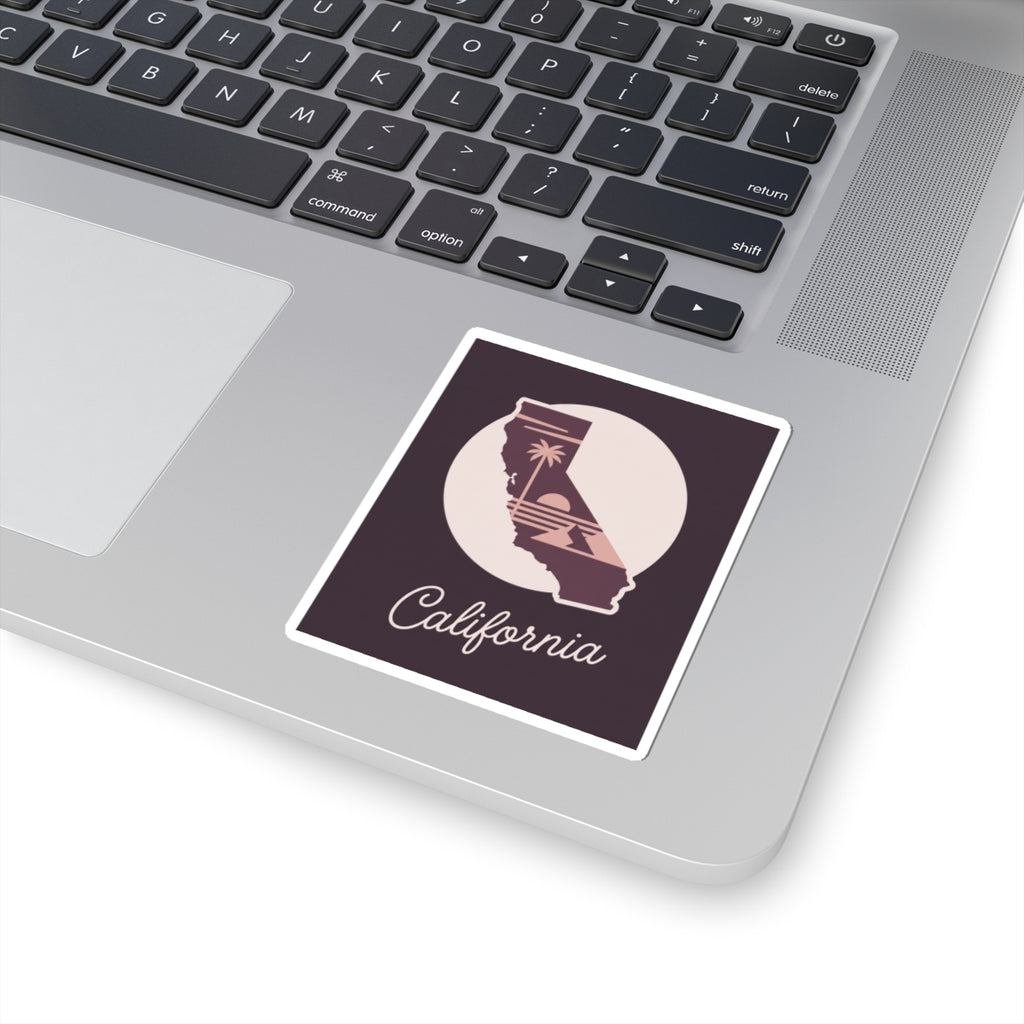 California sticker on a laptop keyboard, mauve state silhouette with “California” script