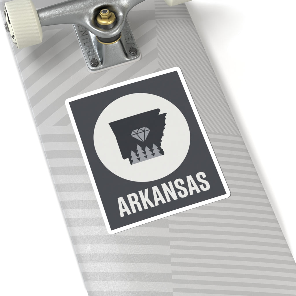 Arkansas kiss-cut vinyl sticker on notebook: state silhouette with diamond trees and ARKANSAS