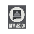 Square metal wall art sign with New Mexico text and skyline graphic in a circle