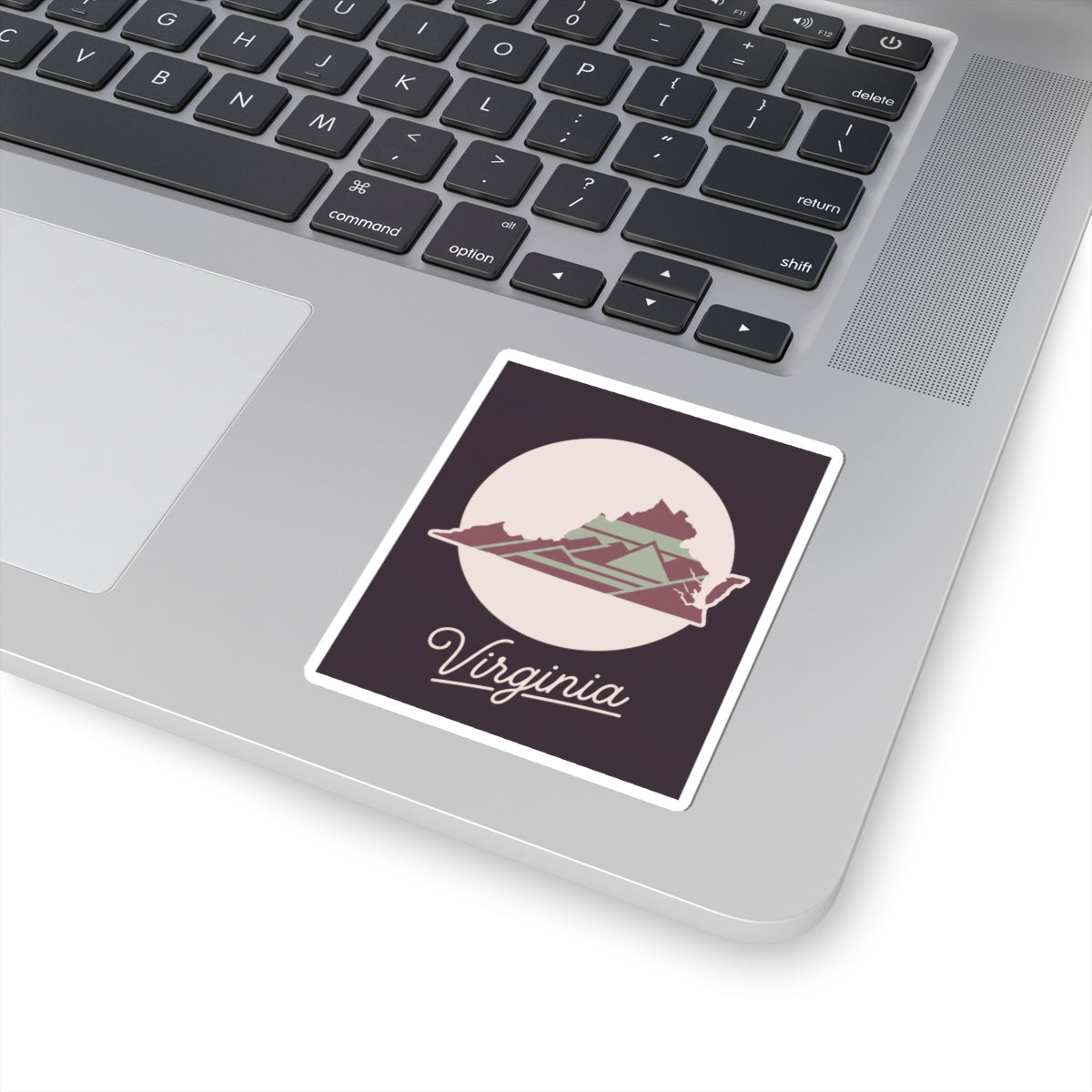 Virginia decal on a laptop keyboard: state graphic and “Virginia” script