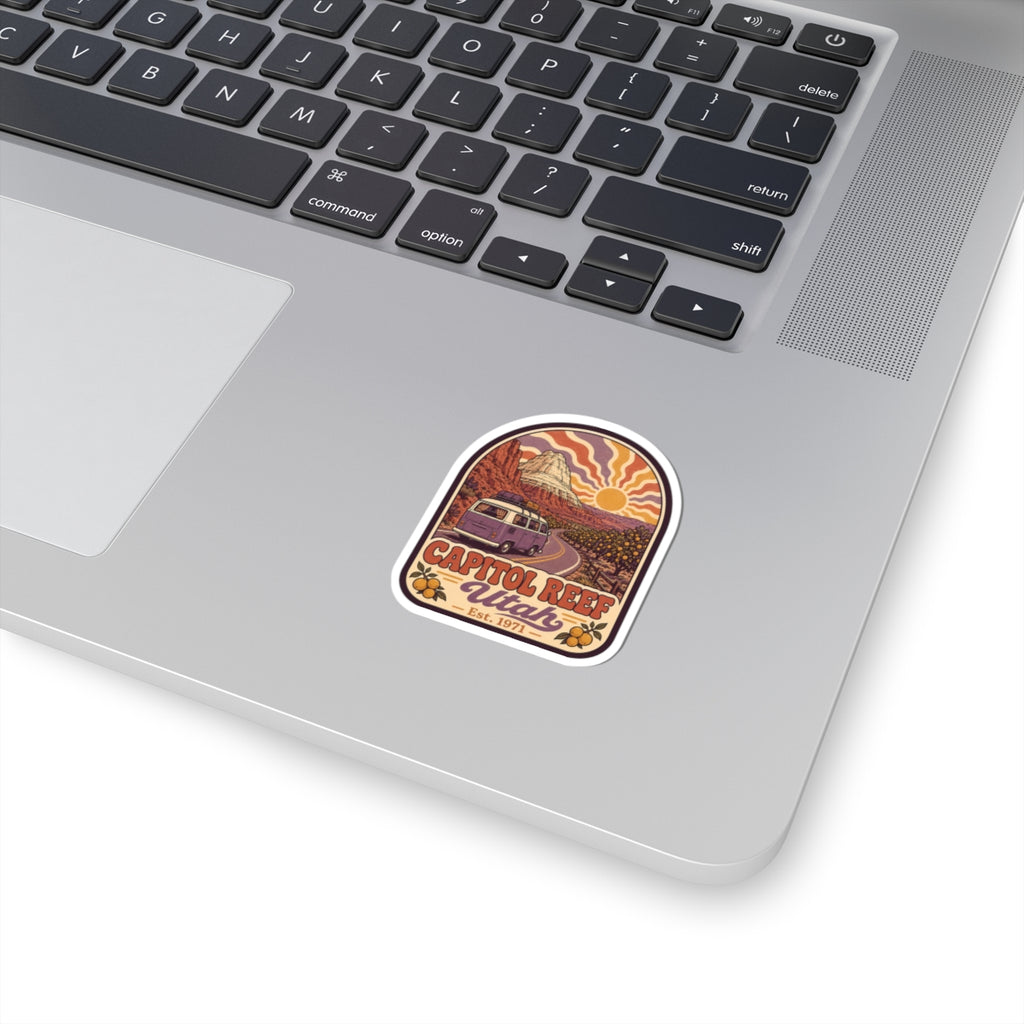 Rounded kiss-cut sticker with desert landscape, camper van, and desert sun icon