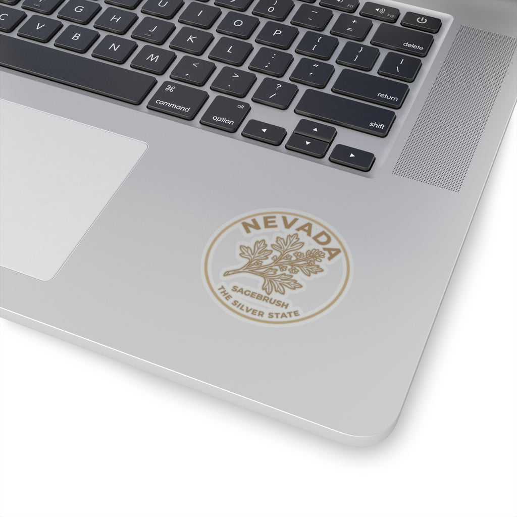 Circular Nevada transparent vinyl sticker on light gray surface with sagebrush and Silver State text