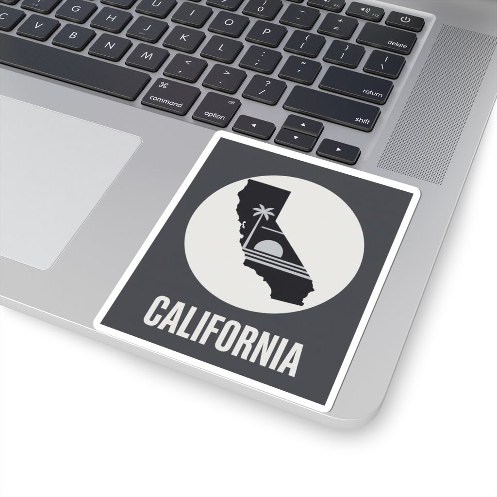 California state silhouette sticker with palm tree icon and CALIFORNIA text on laptop, angled