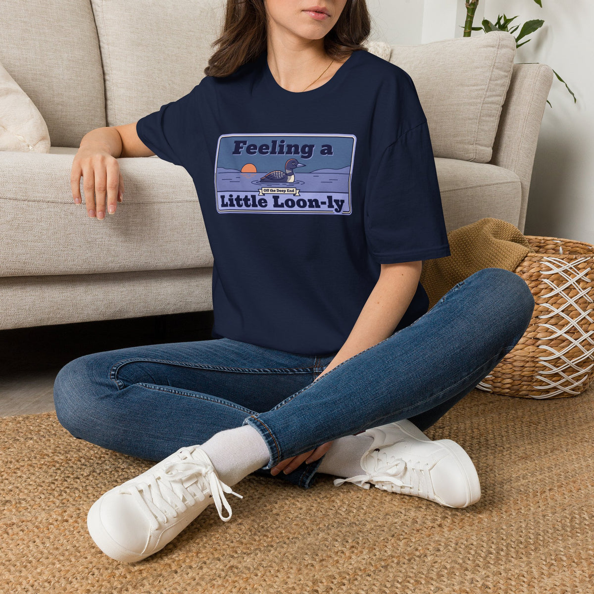 Navy graphic t-shirt with loon pun slogan print, worn with jeans and white sneakers