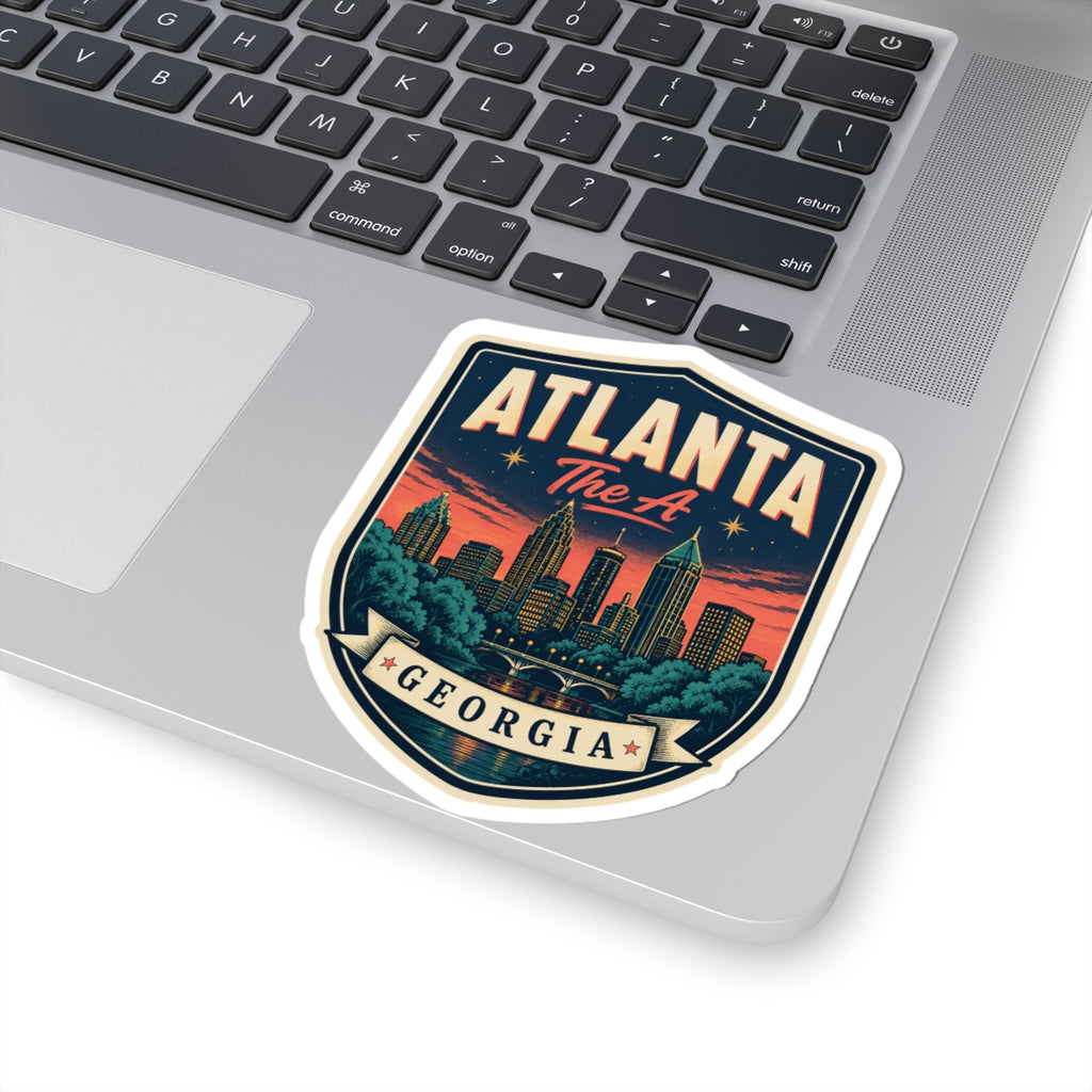 Atlanta Georgia luggage tag sticker on laptop lid, 'ATLANTA' text over city skyline