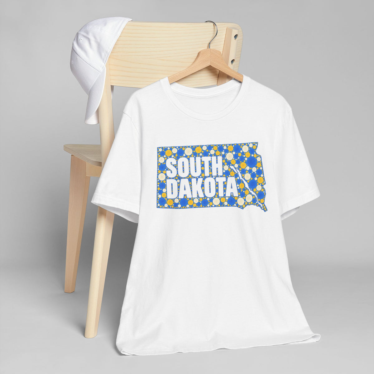 White t-shirt with polka dot South Dakota map graphic in blue and yellow