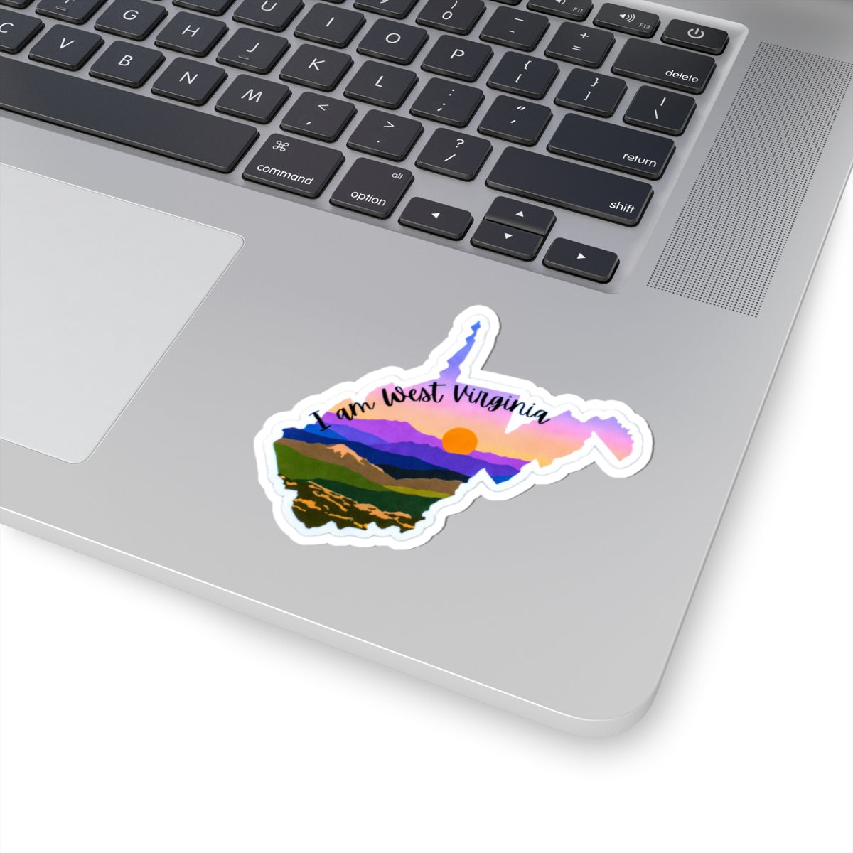 I am West Virginia sticker on laptop: colorful West Virginia map with script text