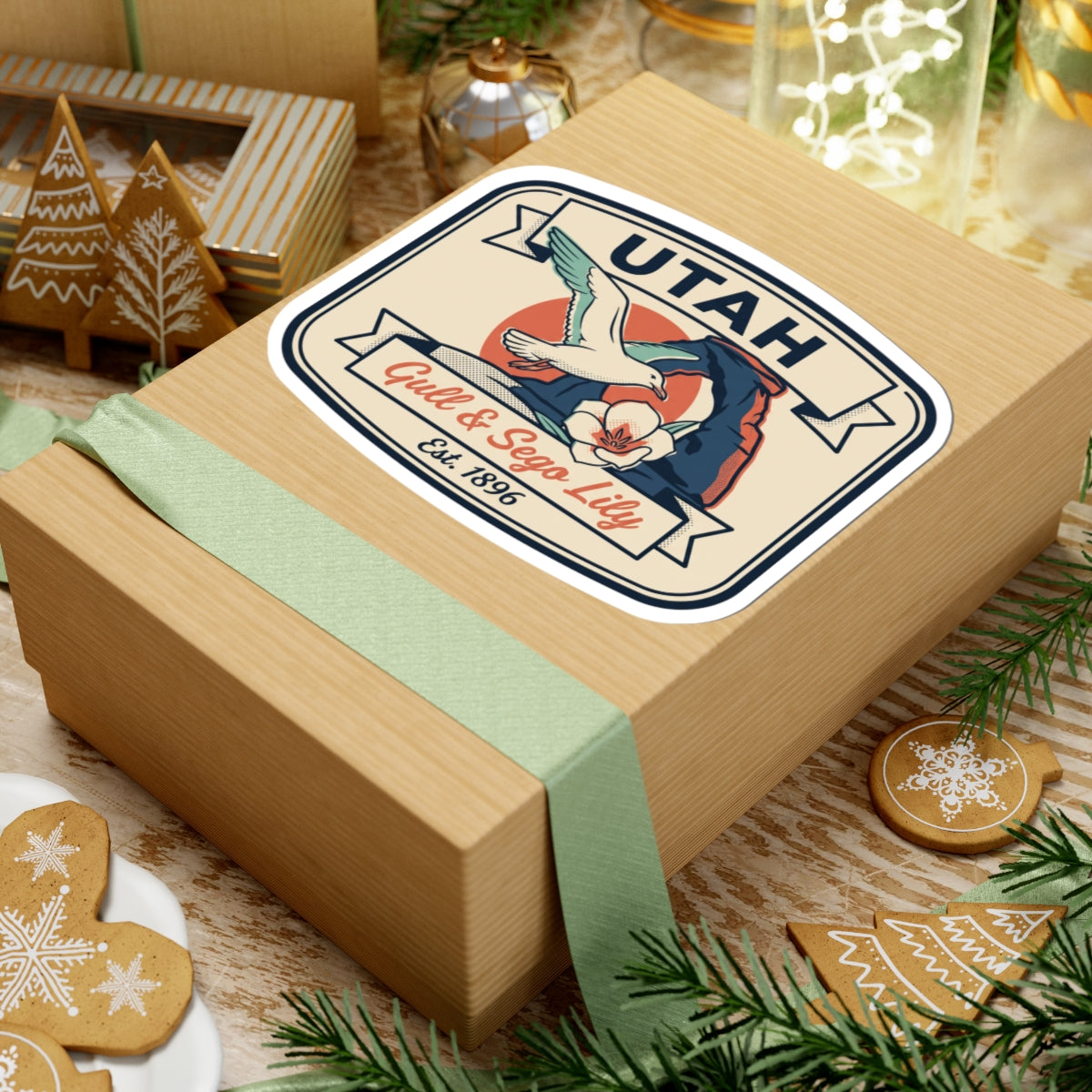 Utah state badge sticker on gift box; gull and sego lily with Est. 1896