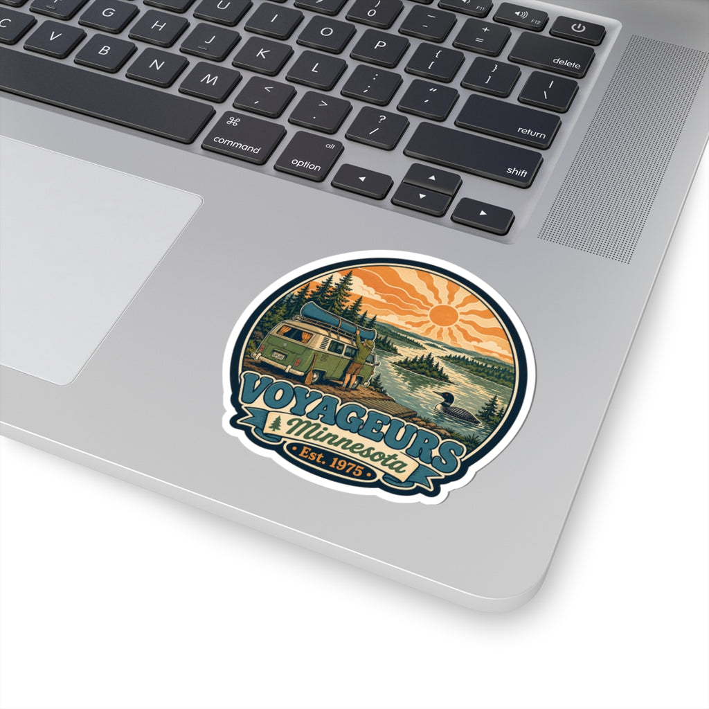 Round die-cut sticker with green camper van landscape, pine trees, lake, orange sun; Est. 1975