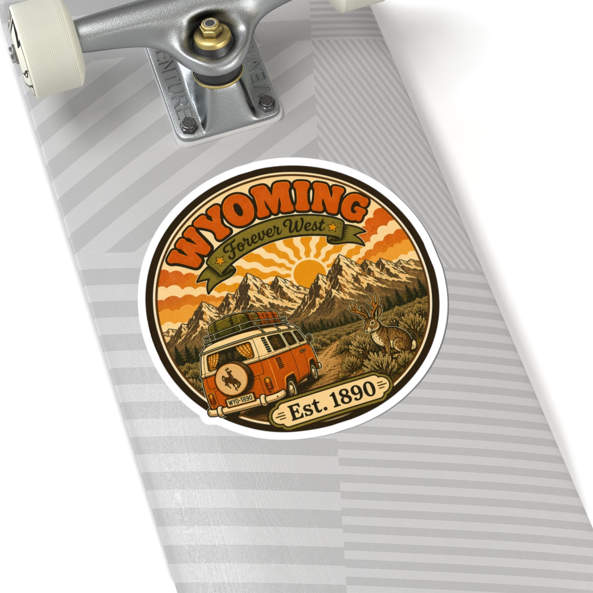 Round kiss-cut vinyl sticker featuring vintage Wyoming artwork with bus, mountains, rabbit, “Est. 1890”