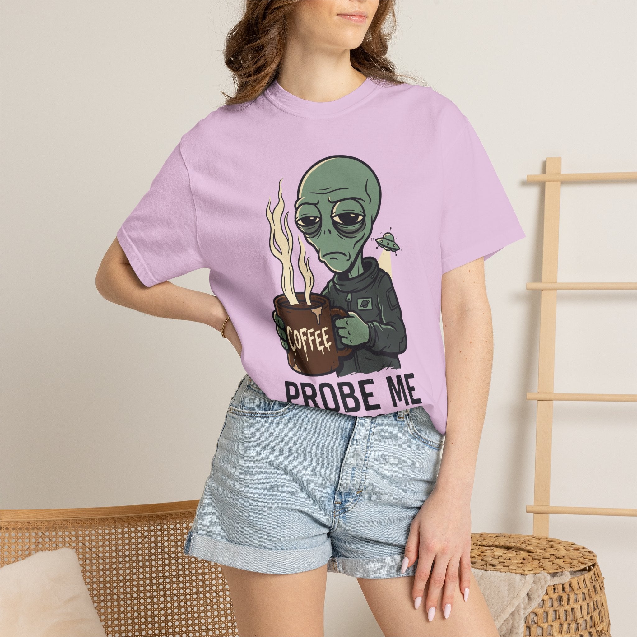 Light purple T-shirt on model with green alien coffee graphic and “PROBE ME” slogan