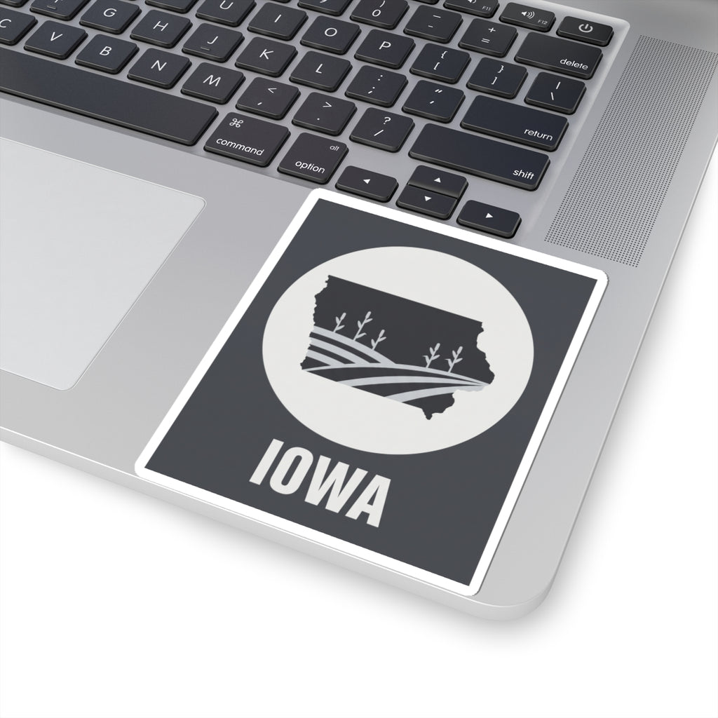 Iowa farmland graphic sticker on a laptop: black square with white circle and “IOWA” text