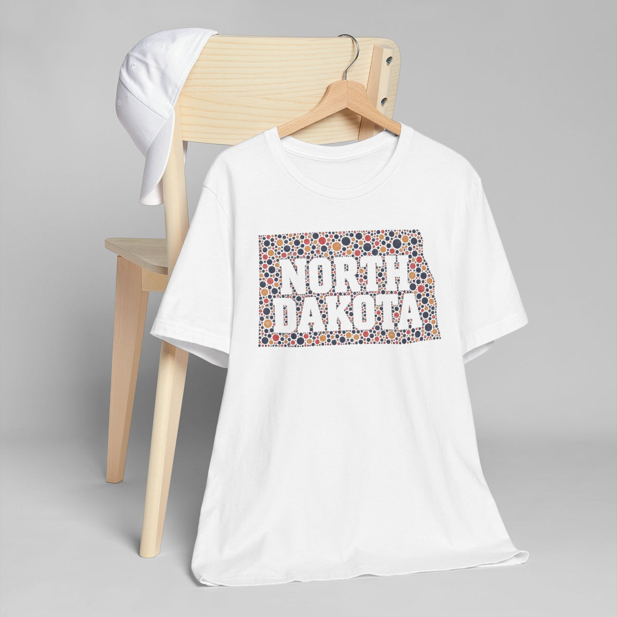 White T-shirt with colorful “NORTH DAKOTA” floral map graphic on front