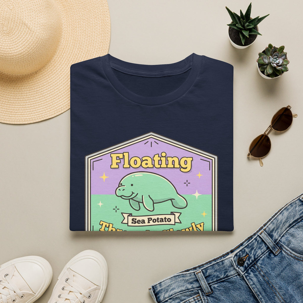 Navy manatee T-shirt with "Floating" sea potato graphic in mint and gold