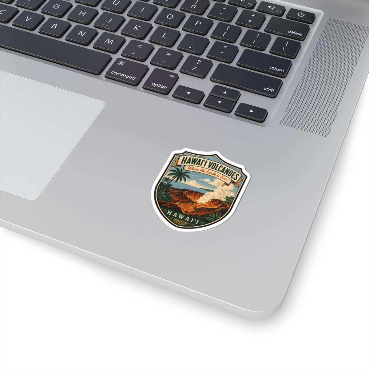 Shield-shaped retro Hawaii volcanoes travel sticker with lava, ocean, and palm trees
