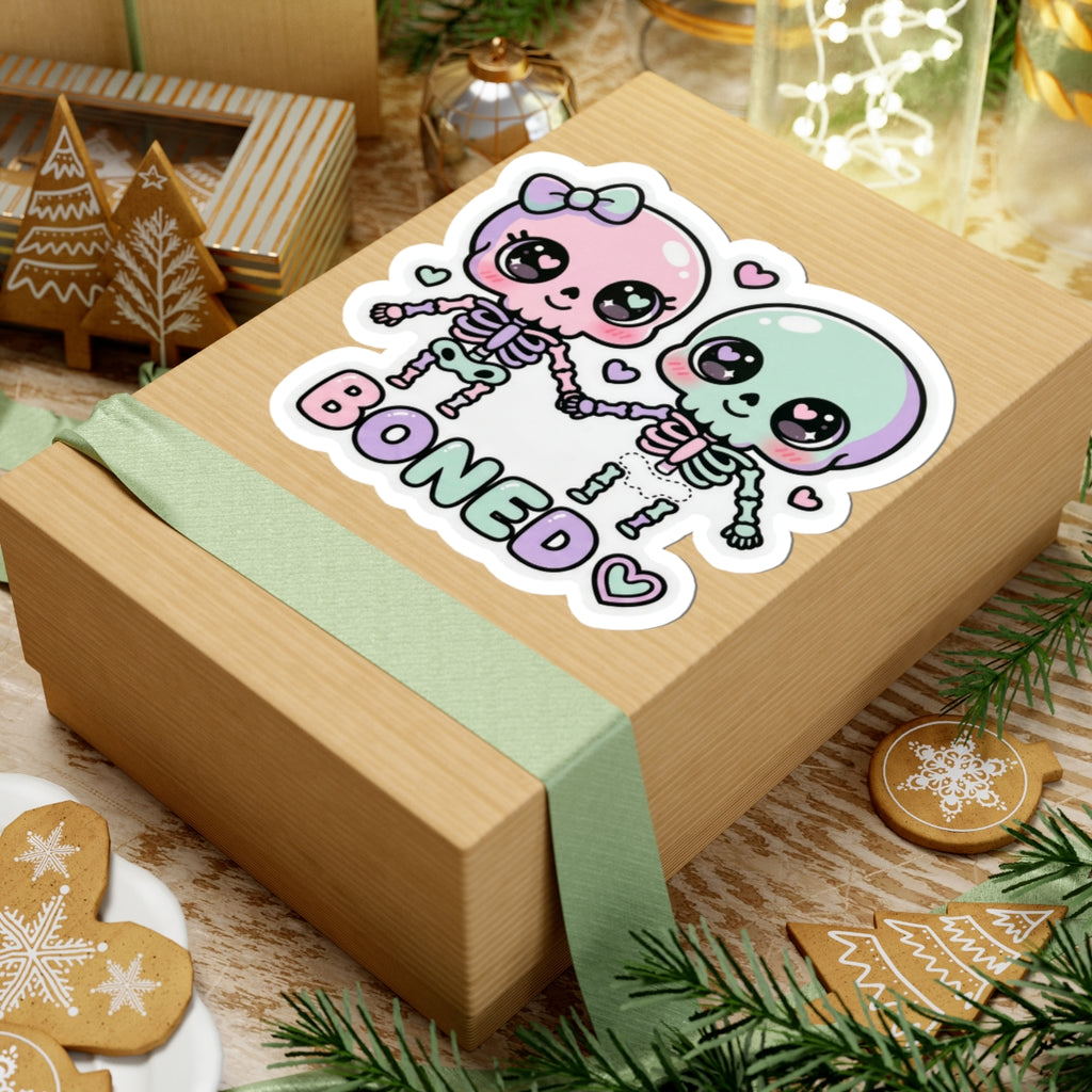 Pastel skeleton couple sticker with two skulls holding hands and 'BONED' word