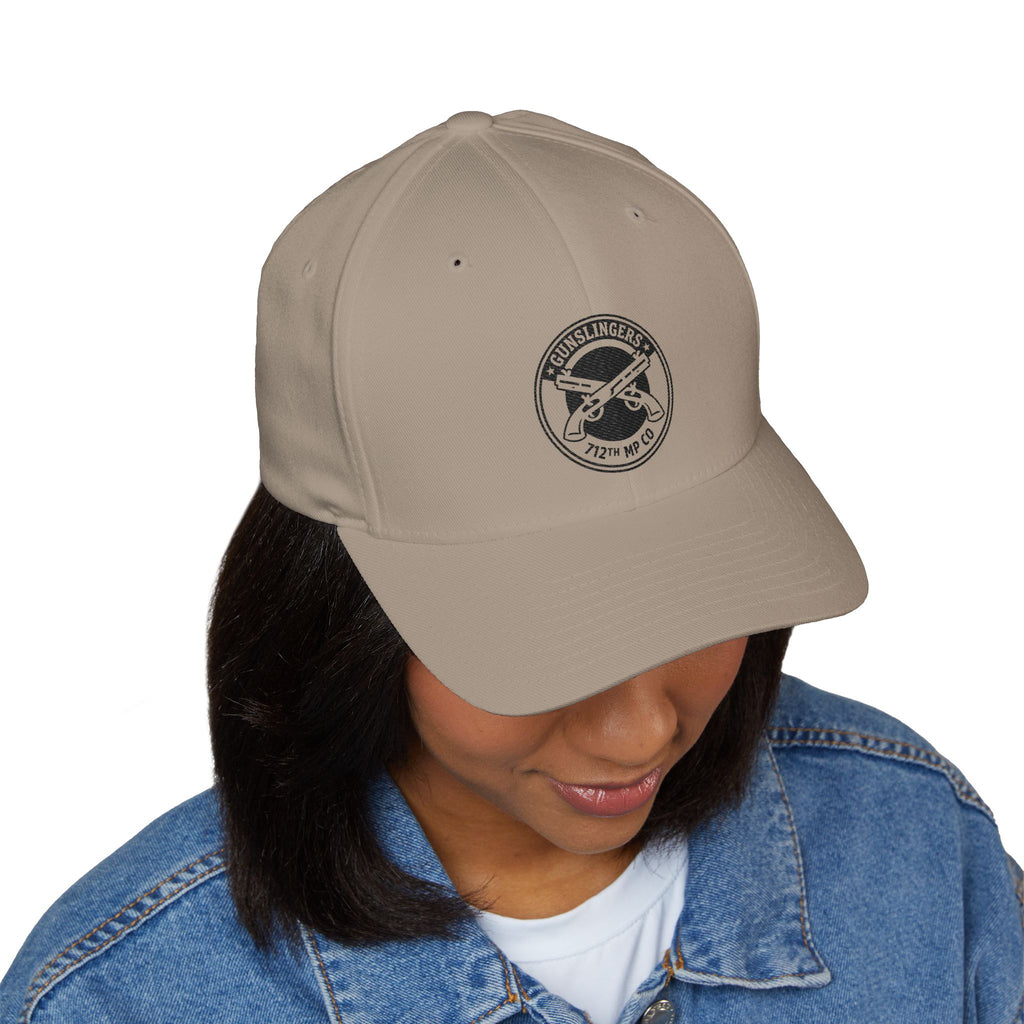 Khaki embroidered baseball cap with round black emblem on front