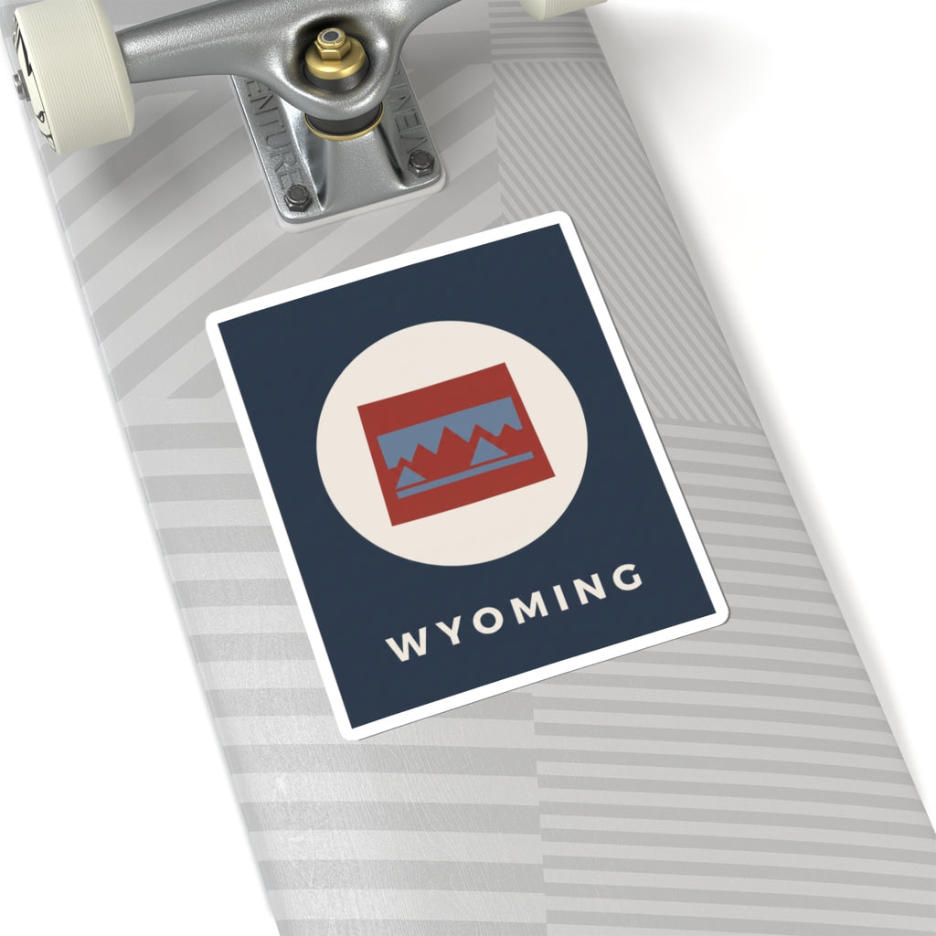 Square Wyoming sticker with circular mountain badge, navy background, and “WYOMING” text.