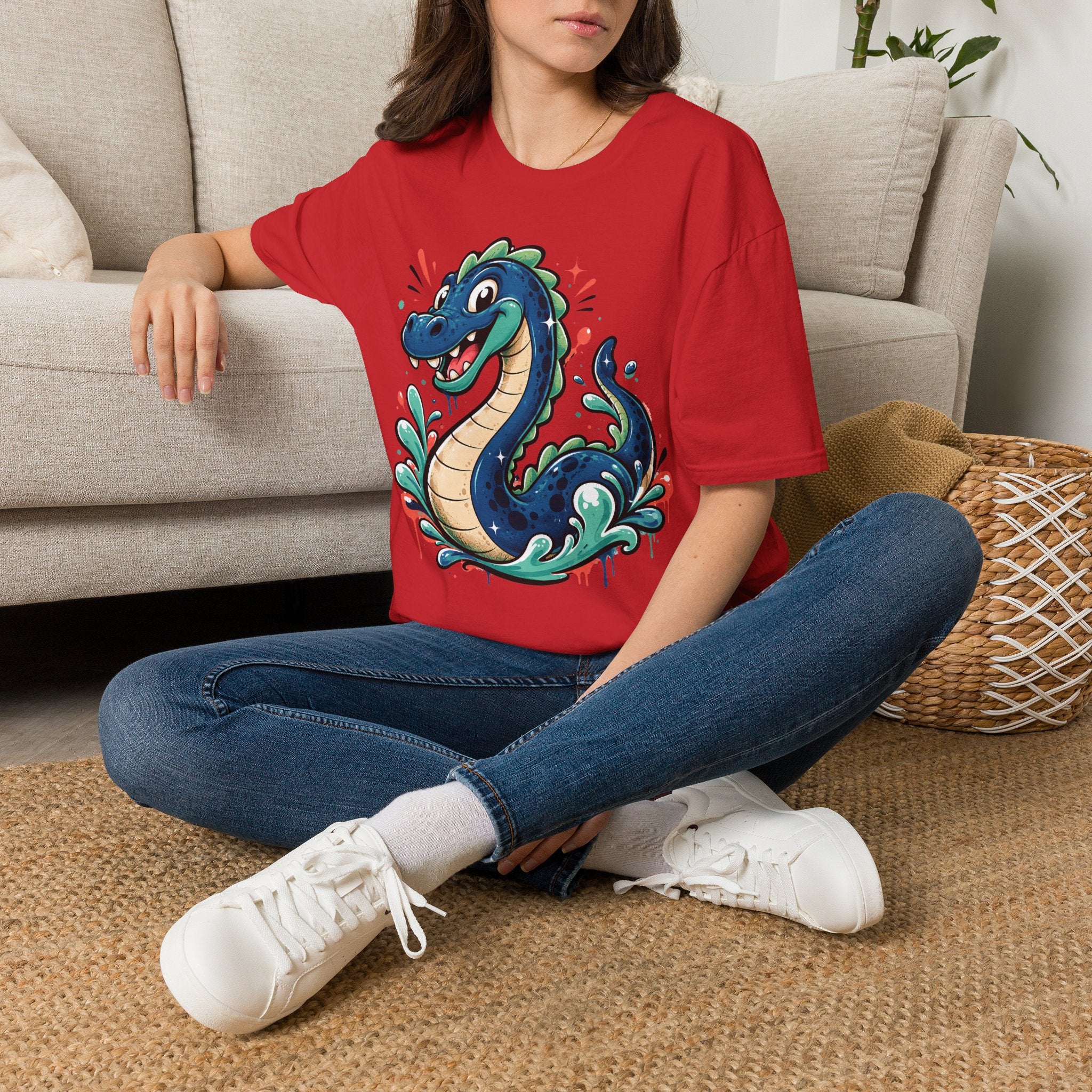 Red short-sleeve T-shirt with colorful cartoon sea serpent graphic on chest.