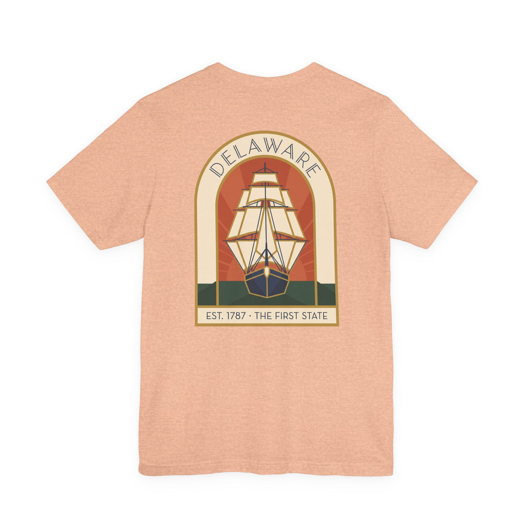 Peach t-shirt with large back graphic of a sailing ship inside a badge